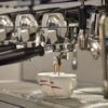 Close-up of the La Cimbali | M26 TE RE espresso machine brewing two cups of coffee.
