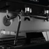 Close-up view of the La Cimbali M40 espresso machine, highlighting its ergonomic design and polished steel finish.